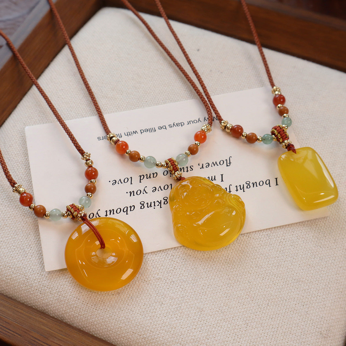 Ethnic Style Buddha Pendant Necklace For Adults With Yellow Braid And Chalcedony Inlay Featuring A Rope Woven Chain