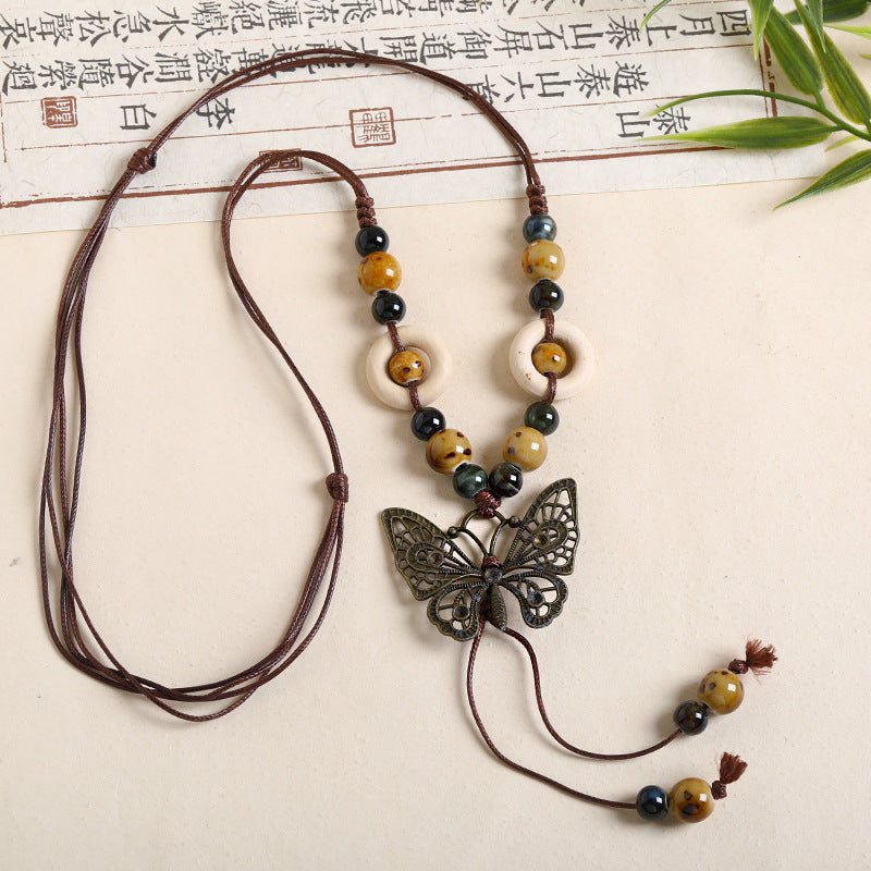 Ethnic Style Unisex Butterfly Braid Sweater Chain Necklace Featuring Ceramic Pendant With Woven Chain