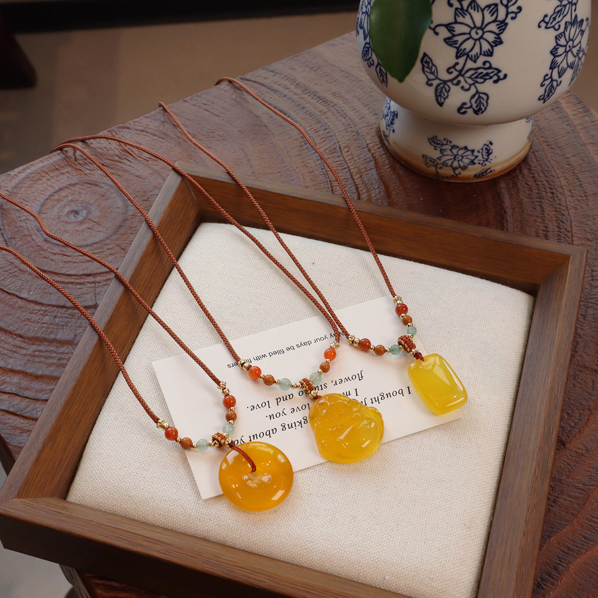 Ethnic Style Buddha Pendant Necklace For Adults With Yellow Braid And Chalcedony Inlay Featuring A Rope Woven Chain