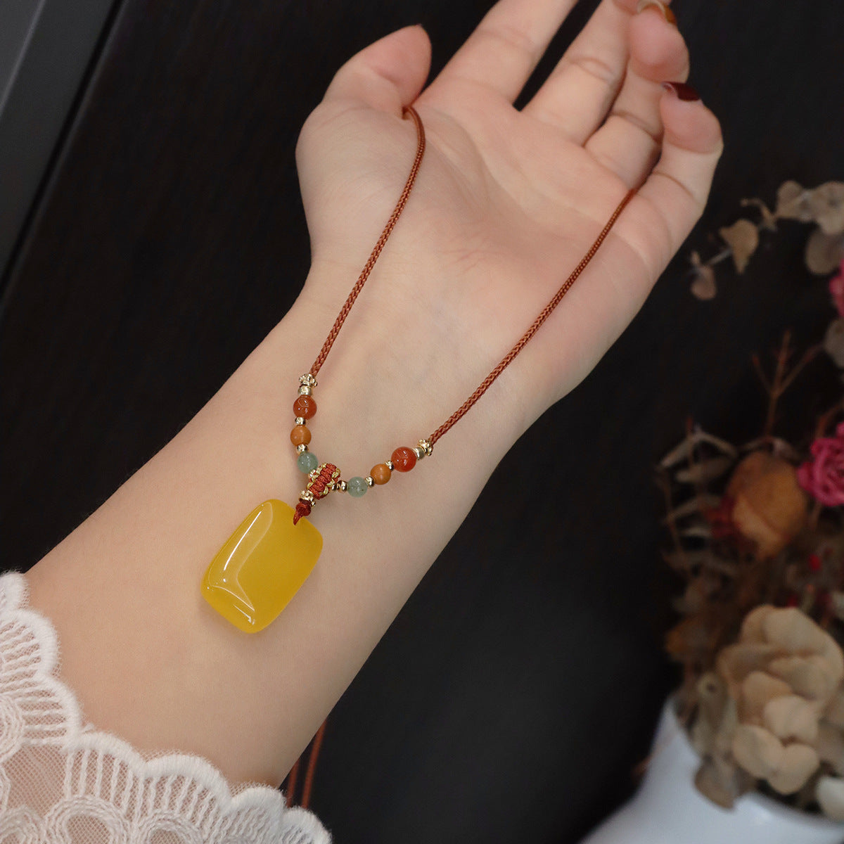Ethnic Style Buddha Pendant Necklace For Adults With Yellow Braid And Chalcedony Inlay Featuring A Rope Woven Chain