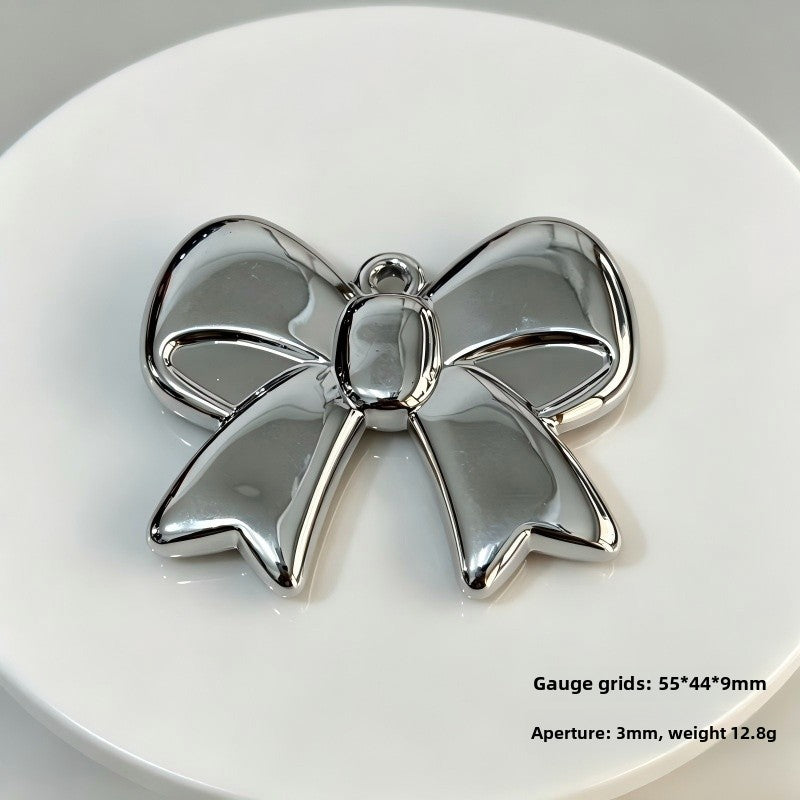 Bow Tie Pendant In Acrylic With KC Golden Plated Finish Featuring Electroplated Silver Jewelry Accessories